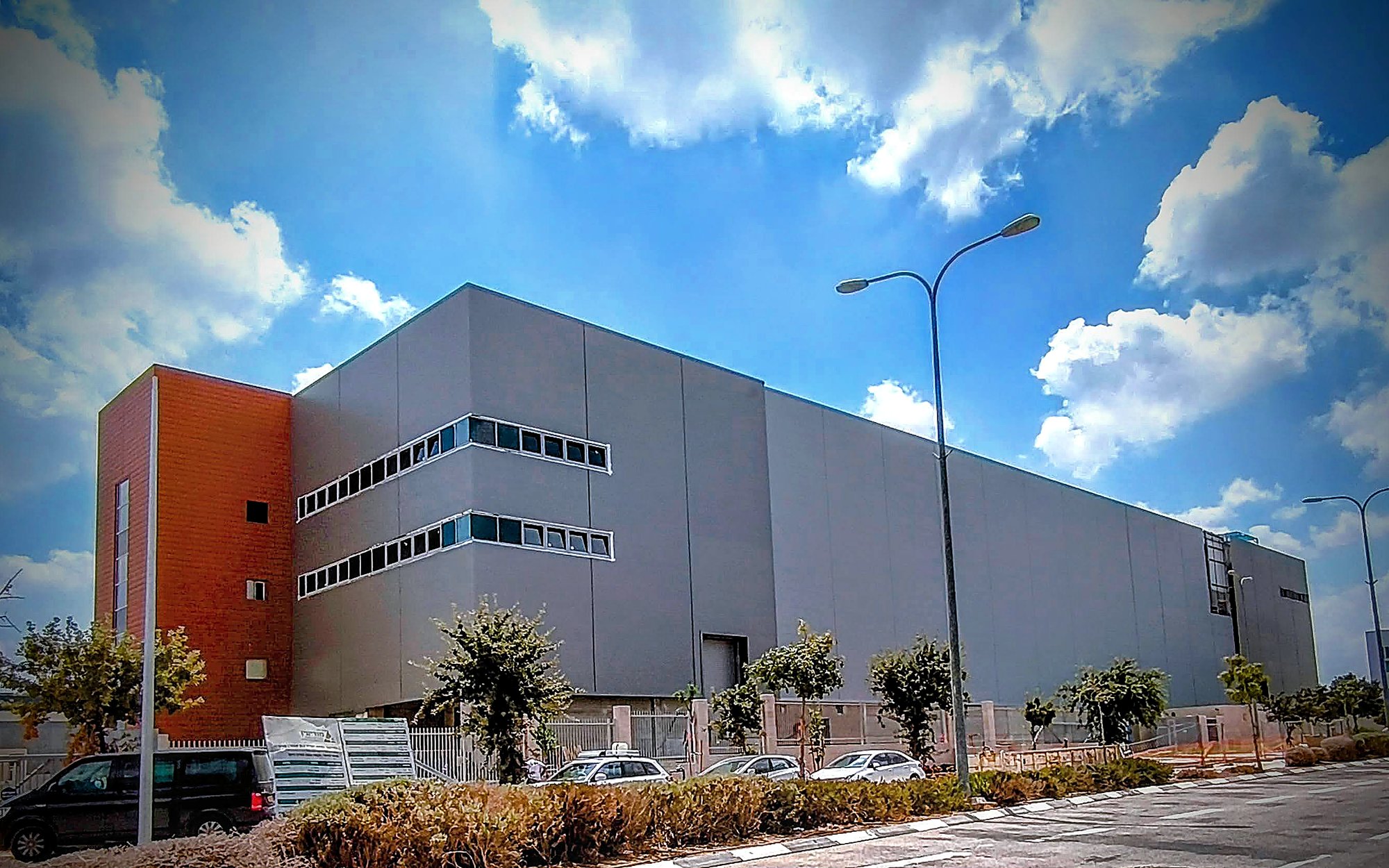 Data Centre, Modi'in — long blind elevation with terracotta plant tower